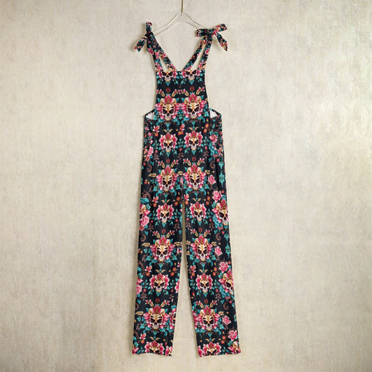 Munsieur luxury floral print jumpsuit with adjustable tie straps and vibrant flower pattern on black background