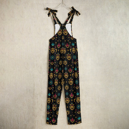 Munsieur designer women's jumpsuit with gold print featuring colorful crown and emblem patterns on black fabric