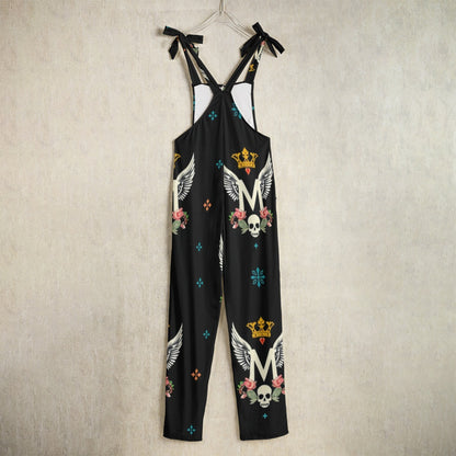 Munsieur luxury all-over print jumpsuit with skulls crowns wings and floral patterns on black fabric