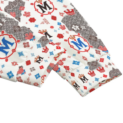 Close-up of Munsieur luxury streetwear joggers with colorful logo and crown patterns on white fabric