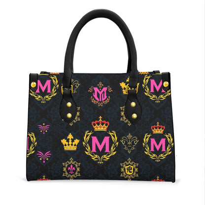 Munsieur printed women's handbag with zip pocket featuring black handles and colorful crown and letter M design